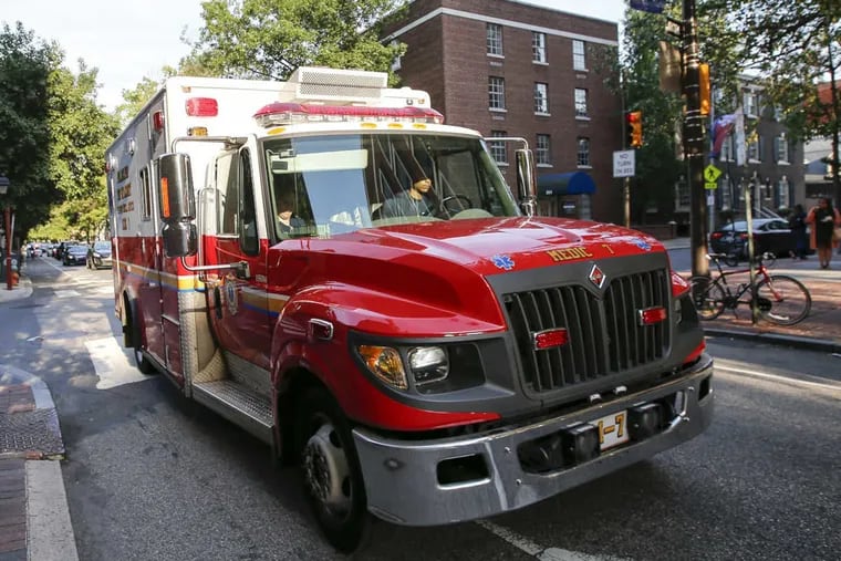 An ambulance drives on the 800 block of Spruce Street in Center City.