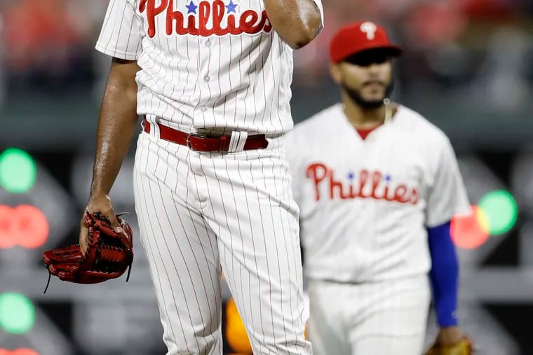 Reliever Seranthony Dominguez removes his hat and glove before being removed by manager Gabe Kapler during the ninth inning of the Phillies' 7-6 loss to the Los Angeles Dodgers at Citizens Bank Park.