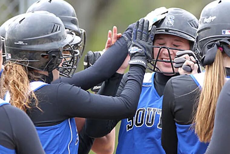 Haileigh Stocks (center) gets congratulated by teammates after hitting a grand slam. (Charles Fox/Staff Photographer)