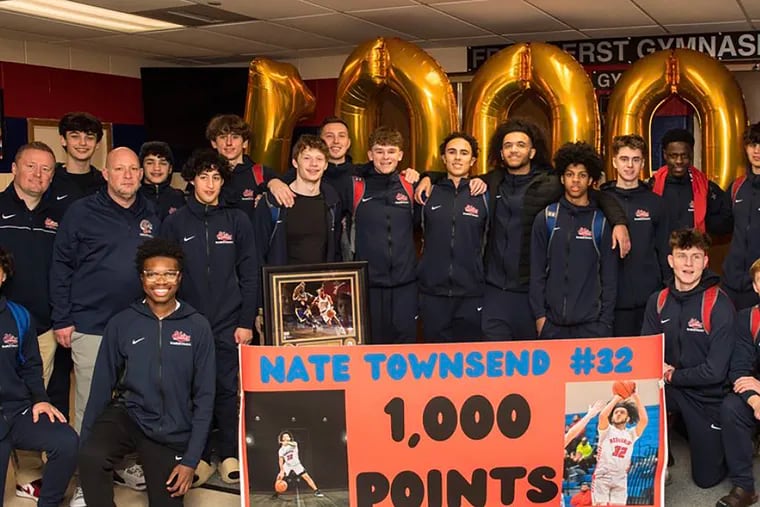 Nate Townsend and his Neshaminy teammates celebrate his 1,000th career point.