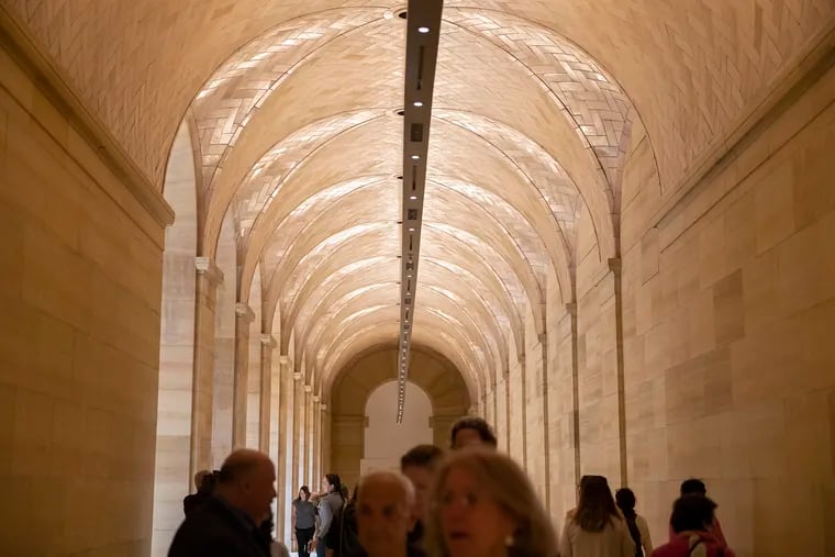 The opening-day crowd walks through the Philadelphia Museum of Art's vaulted walkway entrance.
