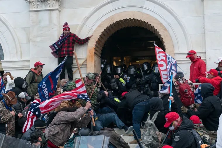 Pro Trump supporters push back against police at the United States Capitol Building in Washington, D.C. which was breached by thousands of rioters on January 06, 2021.