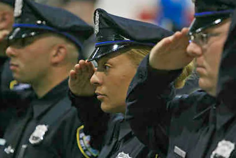 Cadets salute during a ceremony at Rutgers University-Camden. (File Photo)