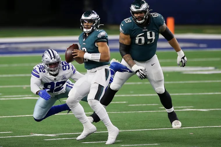 Eagles QB Jalen Hurts (2) prepares to throw the ball under pressure from Dallas Cowboys DE Dorance Armstrong (92) in Sunday's game. The Eagles lost 37-17.