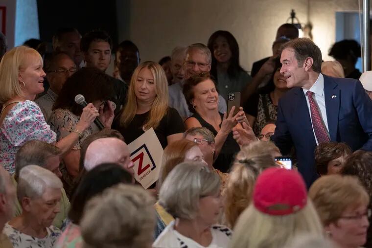 An unidentified woman ask a question to Dr. Mehmet Oz, Republican candidate for the Pennsylvania U.S. Senate, on Thursday, September 8, 2022., during a rally in Springfield, Pa.