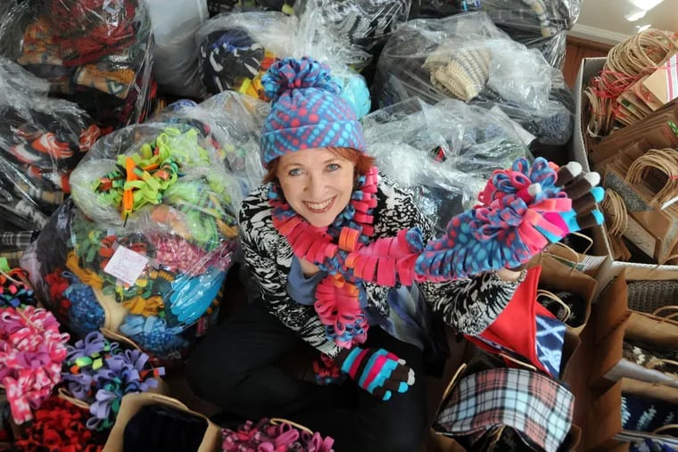 “To me, this is a calling,” says Camille Scott, with holiday packages for the homeless that include her handmade hats and scarves. The Voorhees retiree calls her ministry Warm Hands, Warm Hearts.