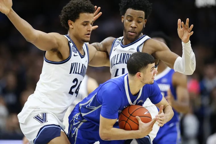Creighton guard Marcus Zegarowski (11) calls for a timeout as he is double-teamed by Villanova forwards Jeremiah Robinson-Earl (24) and Saddiq Bey.