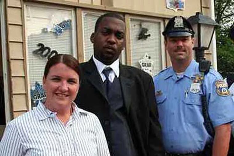 Oronde McClain (second from left) with two of the officers officers who helped him eight years ago: Megan Lynch and Brian Hilbert.