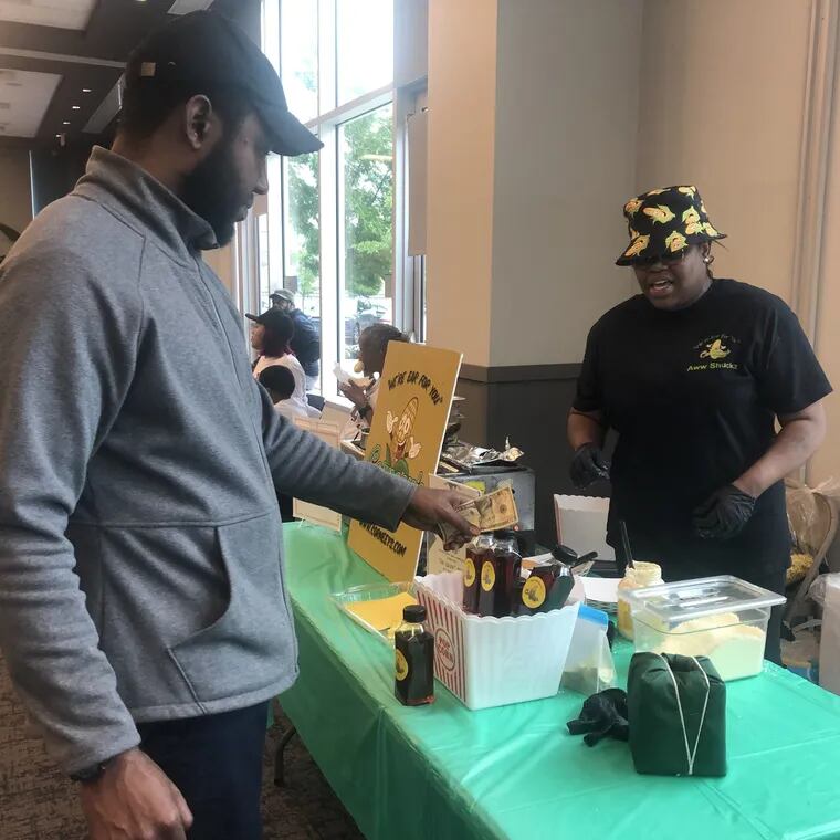 Nija Wiggins, owner of Corneey's, sells gourmet corn on the cob at a pop-up event at the Philadelphia Housing Authority's headquarters in North Philadelphia on Wednesday, May 15, 2024. Wiggins was one of about 40 PHA residents the agency has helped start or grow businesses.