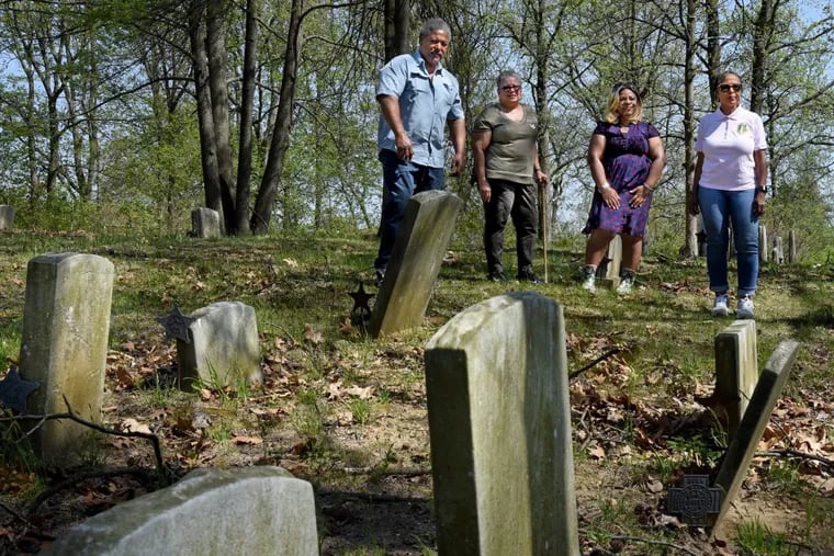 Members of the oversight board of the Mount Peace Cemetery (from left) Cornelius Butler, Yolanda Romero, Dolly Marshall, and Wanda Griffin-Thrower, pose in the section of the cemetery in Lawnside.