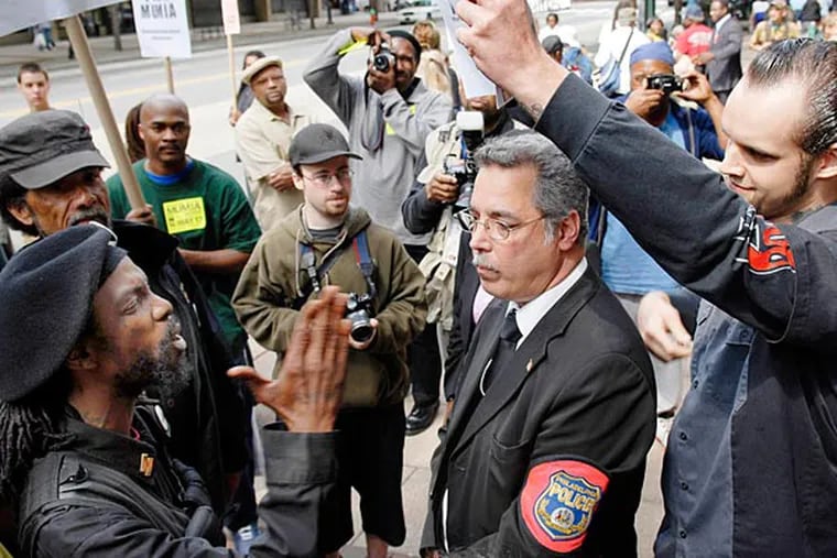 Minister King Samir Shabazz (left), whose given name is Maruse Heath, argues with protesters at a Mumia Abu-Jamal rally in 2007. (David Maialetti/Staff/File)