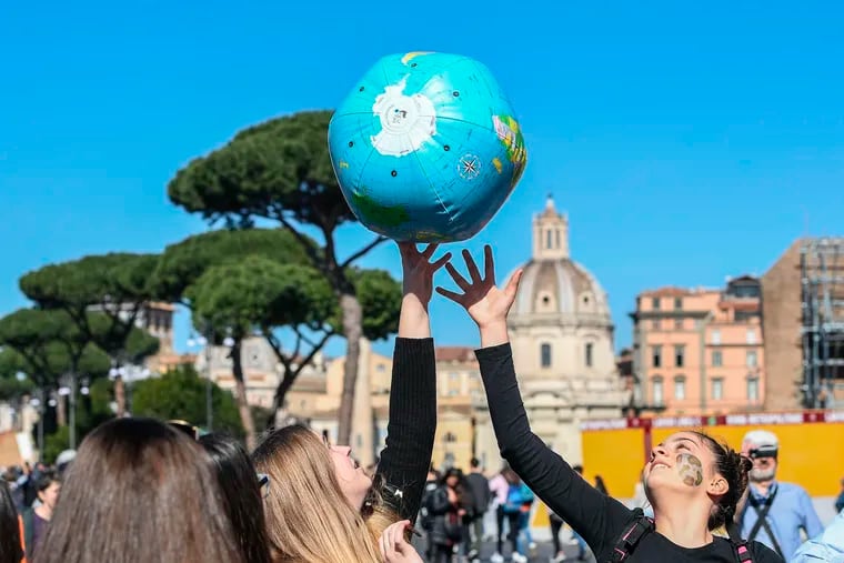 Students play with an inflatable globe as they march to demand action on climate change, in Rome, Friday, March 15, 2019. Students worldwide are skipping class Friday to take to the streets to protest their governments' failure to take sufficient action against global warming.