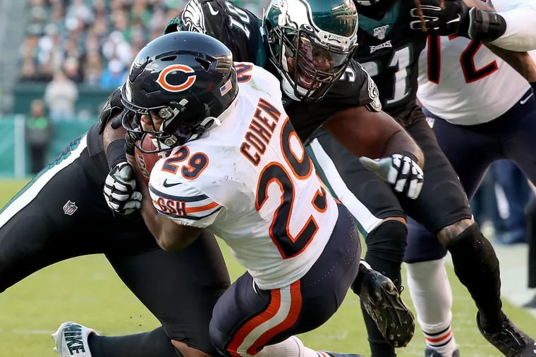Eagles defensive tackle Fletcher Cox tackles Bears running back Tarik Cohen short of the end zone on Sunday.