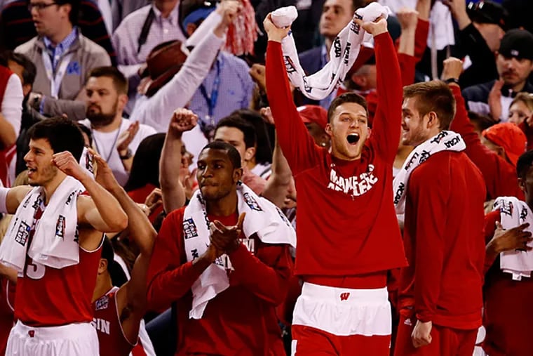 Wisconsin Badgers players react after the 2015 NCAA Men's Division I Championship semi-final game against the Kentucky Wildcats at Lucas Oil Stadium. Wisconsin won 71-64. (Brian Spurlock/USA Today)