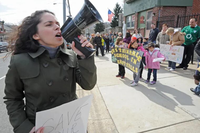 Outside St. Bridget's Catholic Church, Christina Spino leads demonstrators as they rally to save the elementary school on March 4. (April Saul / Staff Photographer)