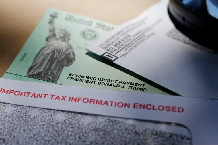 In this April 23, 2020, photo, President Donald Trump's name is seen on a stimulus check issued by the IRS to help combat the adverse economic effects of the COVID-19 outbreak, in San Antonio. The US government has distributed about 130 million economic impact payments to taxpayers in less than 30 days. The IRS anticipates sending more than 150 million payments as part of a massive coronavirus rescue package. The distribution has had some hiccups, including an overwhelmed website, payments to deceased taxpayers and money sent to inactive accounts. (AP Photo/Eric Gay)