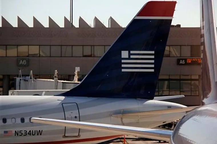 FILE - US Airways jets are seen at Phoenix Sky Harbor International Airport, in Phoenix. Nonstop daily flights between Philadelphia and Edinburgh will begin in May on US Airways. (AP Photo/Gene J. Puskar/File)