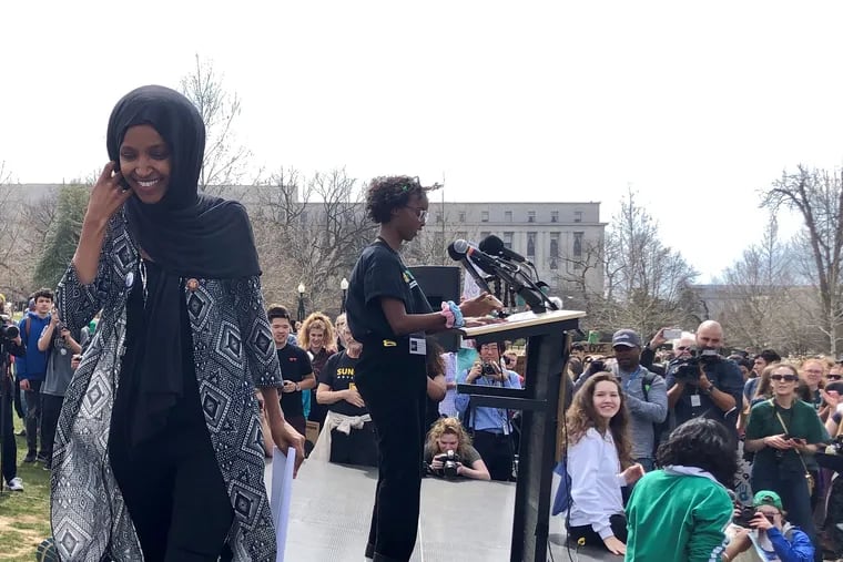 Rep. Ilhan Omar (left) leaves the stage after introducing her daughter, Isra Hirsi, 16, one of the national organizers of last Friday's national Youth Climate Strike.