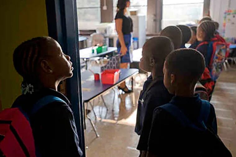 Iyanna Clark and her first-grade classmates wait to be checked in to Katie Harbaugh's class at Harrity, taken over by Mastery Charter Schools. (Clem Murray/Staff)