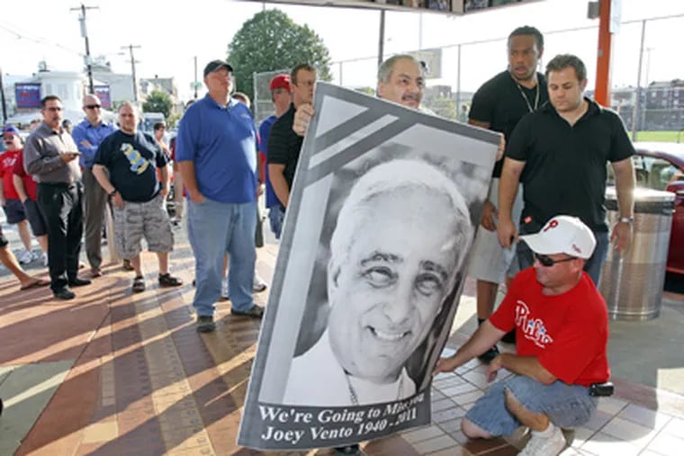 Rene Kobeitri, owner of Rim Cafe at the Italian Market, delivers a memorial photo of Joey Vento to Geno's Steaks. (Steven M. Falk / Staff Photographer)