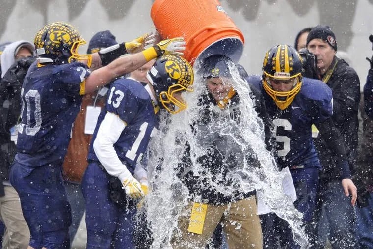 Kirtland, Ohio, football players pour ice over head coach Tiger Laverde after a major playoff win Dec. 6, 2013. Pouring ice or water over their own heads could be a good option to stay cool.