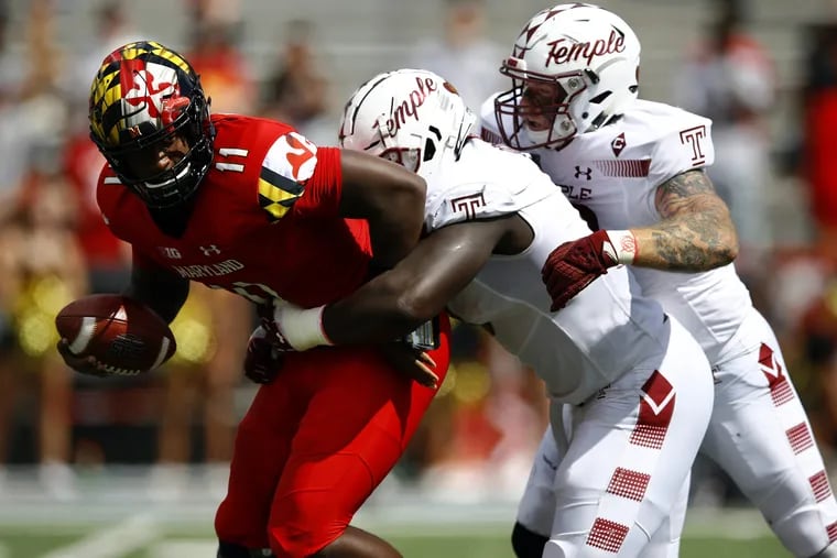 Maryland quarterback Kasim Hill, left, getting sacked by Temple defensive tackle Michael Dogbe, center, and defensive end Jimmy Hogan during the teams' game last September.