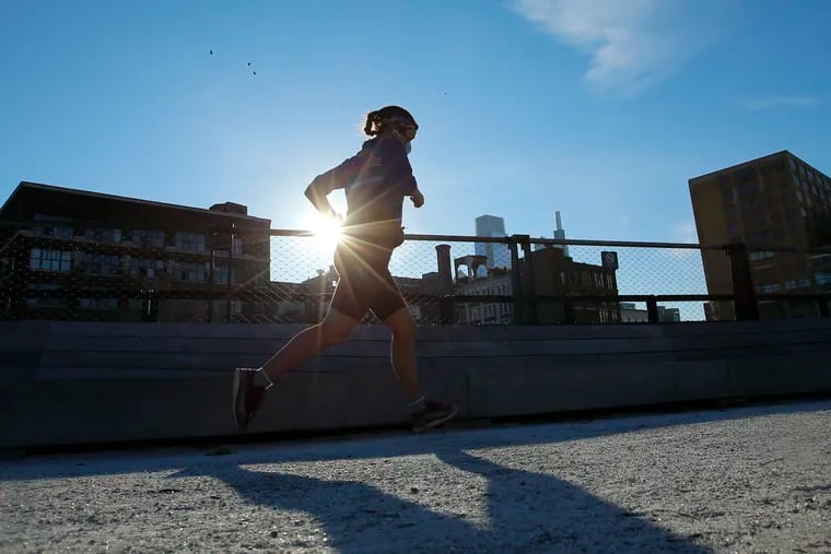 A jogger runs on along a trail at the Rail Park in the Callowhill neighborhood on Sunday, November 29, 2020.