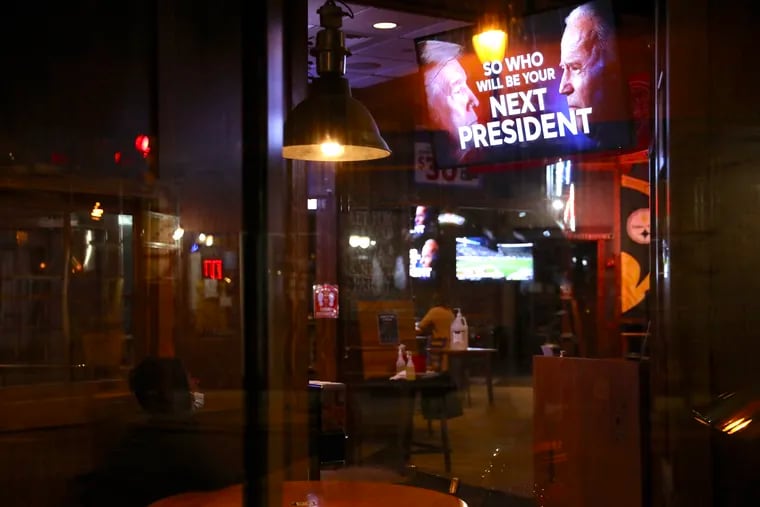 A customer watches early presidential election returns at Fox and Hound in Philadelphia on Election Day, Nov. 3.
