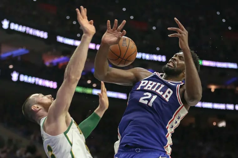 Joel Embiid collides with the Celtics' Aron Baynes during Wednesday's win.