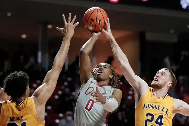 Templeâ€™s # 0 Khalif Battle will have his shot tapped away by La Salleâ€™s # 24 Christian Ray in the first half of the La Salle University at Temple University mens basketball game at Templeâ€™s Liacouras Center in Phila., Pa. on Dec. 1, 2021.