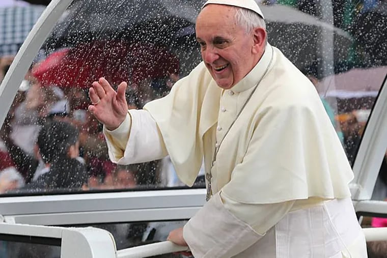Pope Francis waves to people from his popemobile in Rio de Janeiro, Brazil, Saturday, July 27, 2013. (AP Photo/Andre Penner)