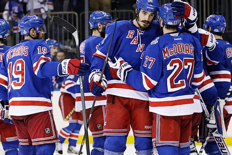 Rangers center Brian Boyle (22), center, greets defenseman Ryan McDonagh (27) after the Rangers beat the Los Angeles Kings 2-1 in Game 4 of the NHL hockey Stanley Cup Final, Wednesday, June 11, 2014, in New York. (Seth Wenig/AP)