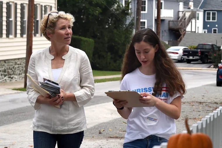 Chrissy Houlahan (left), Democratic candidate for Pennsylvania's 6th congressional district, walks with campaign volunteer Dylan Ward, 17, a senior at Conestoga High School, while canvassing in Malvern.
