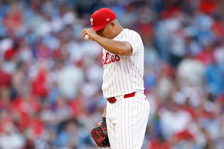 Phillies pitcher Ranger Suarez pulls down his cap before throwing a pitch against the St. Louis Cardinals on June 1.