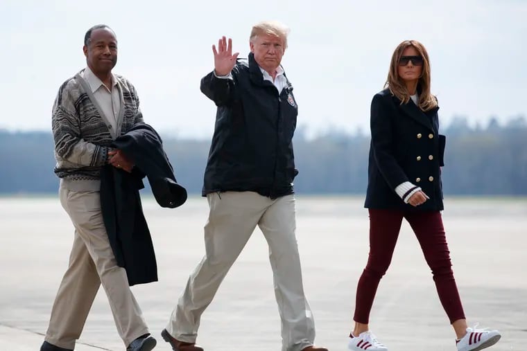 President Donald Trump, first lady Melania Trump, and Secretary of Housing and Urban Development Ben Carson walk from Marine One to board Air Force One at Lawson Army Airfield, Fort Benning, Ga., Friday, March 8, 2019.