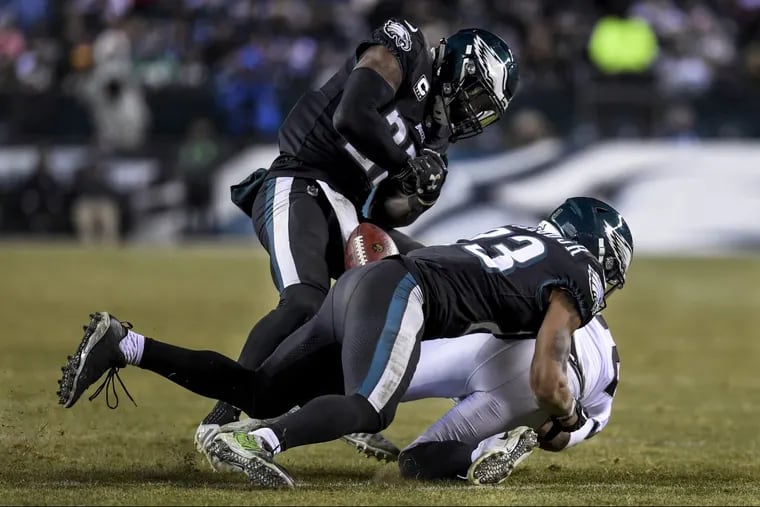 Safety Malcolm Jenkins strips the ball from Oakland Raiders running back Jalen Richard as fellow safety Rodney McLeod makes the tackle during the Eagles’ 19-10 win Monday night.