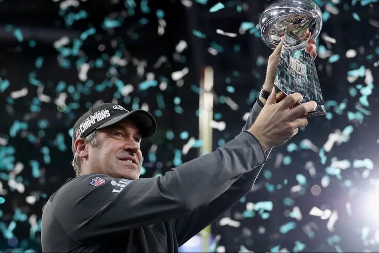 Eagles head coach Doug Pederson hoisting the Lombardi trophy during the ceremony after Super Bowl LII.
