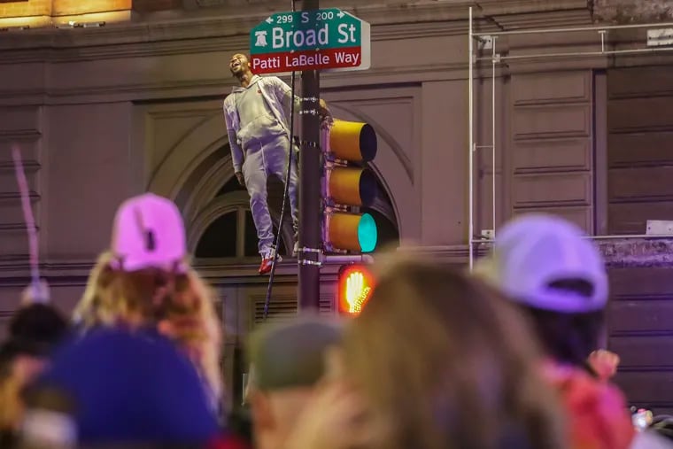 A pole-climber at Broad and Locust st. in Philadelphia after the Phillies defeated the Padres to move on to the World Series on Oct. 23.