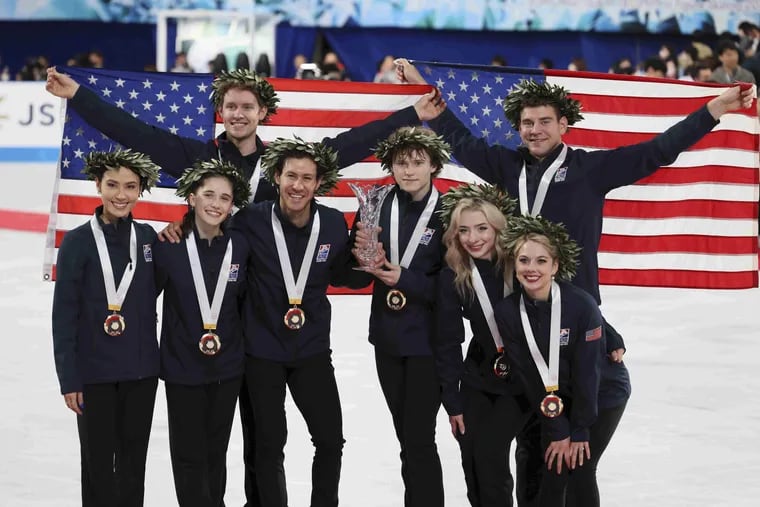 South Jersey figure skater Isabeau Levito, 16, (second from left) and the rest of Team USA celebrate winning the gold medal at the ISU World Team Trophy 2023 at Tokyo Metropolitan Gymnasium. The rest of the team included (from left) Madison Chock, Evan Bates, Jason Brown, Ilia Malinin, Amber Glenn, Alexa Knierim, and Brandon Frazier.