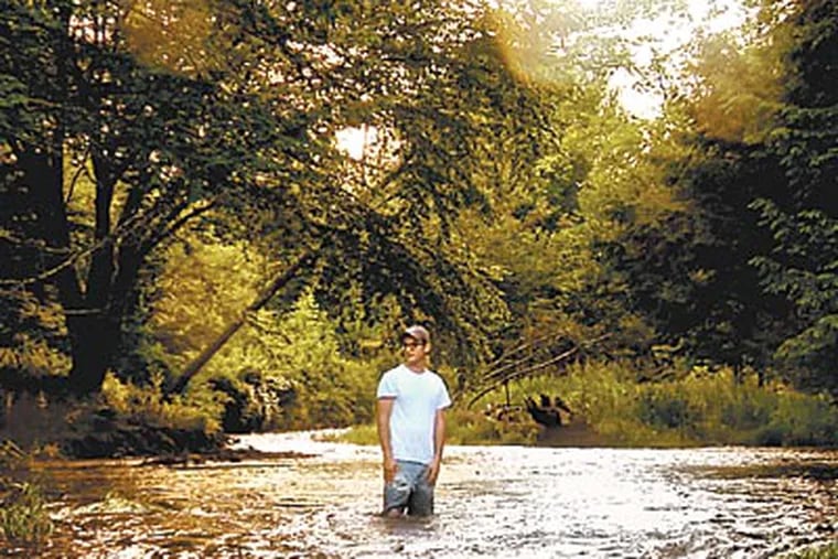 Josh Fox standing in a stream near Dimock, Pa., where residents' animals began to lose their hair after drilling started, presumably from drinking contaminated water. It is part of &quot;Gasland.&quot;