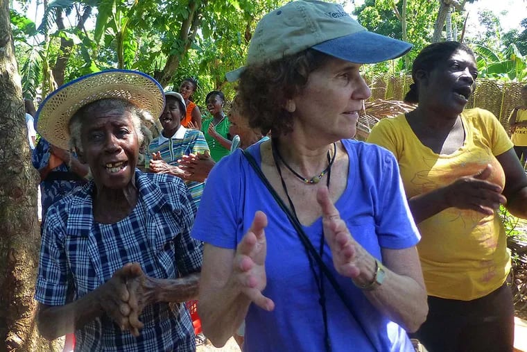 At one WIL meeting for the micro-finance institute Fonkoze in Haiti, WIL co-founder  Linda Resnick ( right ) sings and dances with some of the women.