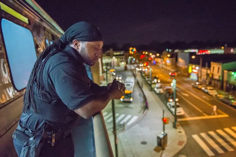Jason Khan, a revenue attendant on one of SEPTA's Money Trains, looks over the city while a train traveling in June of 2016 was temporarily stopped above ground near the Frankford Transport Center.