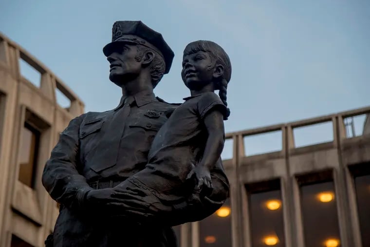 A sculpture depicting a uniformed police officer holding a small child in his arms, symbolizing the protective role of the police officer in the community. The statue is expected to be installed at the new police headquarters in the Philadelphia Public Services Building (PPSB) at 400 N. Broad St.