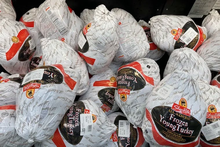 Frozen turkeys are displayed at a supermarket in Philadelphia last year. Americans are bracing for a costly Thanksgiving this year, with double-digit percent increases in the price of turkey, potatoes, stuffing, canned pumpkin, and other staples.