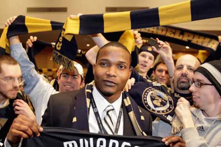The Philadelphia Union's first overall pick Danny Mwanga poses with fans. (David Maialetti / Staff Photographer)