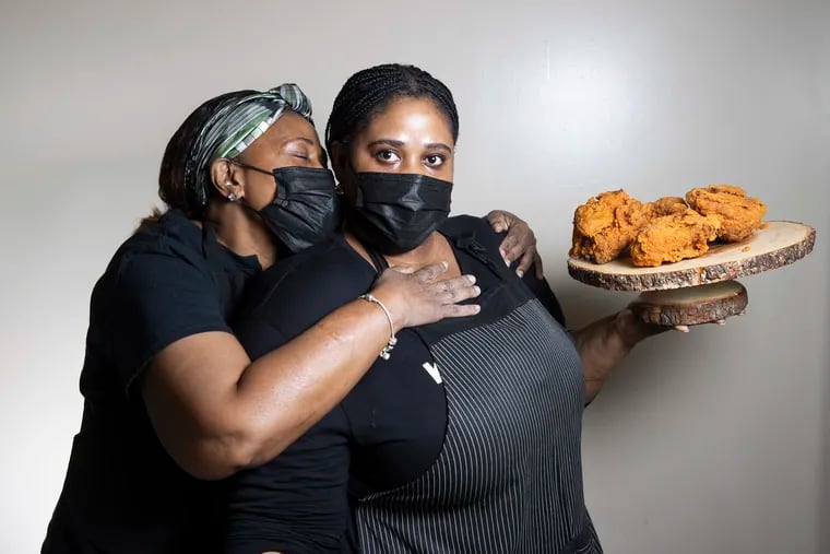 Abbygale Bloomfield (right) with her mother, Sandra Brown, and their jerk fried chicken at Kingston 11.