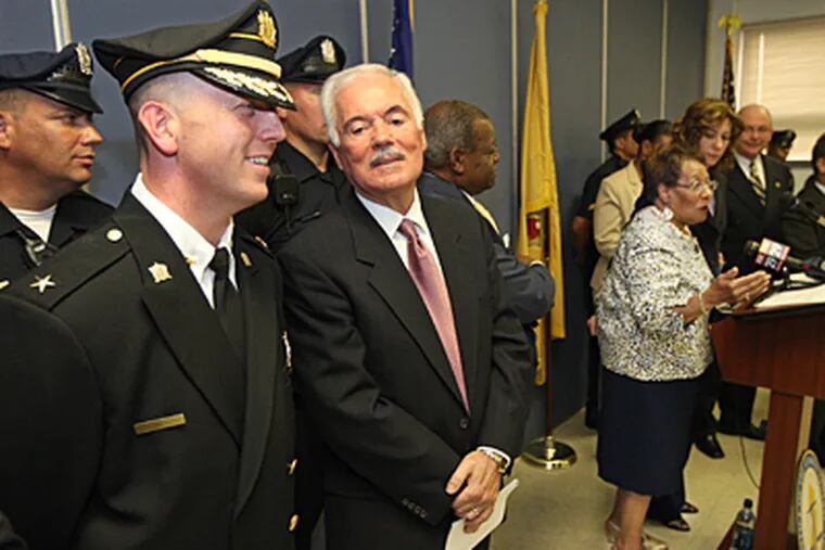 Camden's new Chief of Police, John Thomson, left, with Camden's new Police Director, Louis Vega, second from left. Camden's Mayor, Gwen Faison, right. (Michael Bryant / Inquirer)