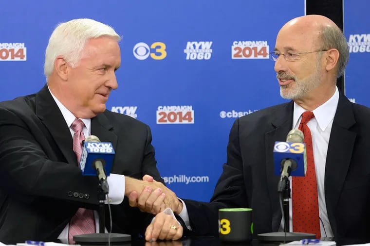 Gov. Tom Corbett (left) and Democratic candidate Tom Wolf (right) shake hands before their debate at KYW Newsradio's Philadelphia studio. (TOM GRALISH / Staff Photographer )