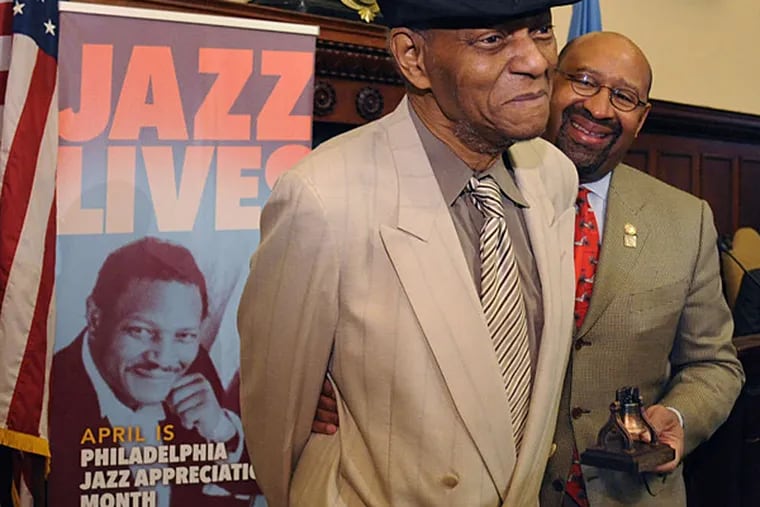 As Mayor Nutter awaits, Liberty Bell in hand, McCoy Tyner is named 2015 Jazz Legend Honoree at ceremonies yesterday. (CLEM MURRAY / STAFF PHOTOGRAPHER )