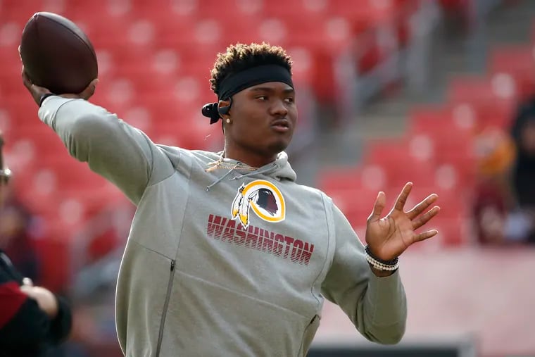 Washington Football Team quarterback Dwayne Haskins warms up during his rookie season, the final year the team employed a mascot considered to be a racial slur against Native Americans.